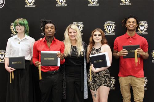 Four graduates with their principal